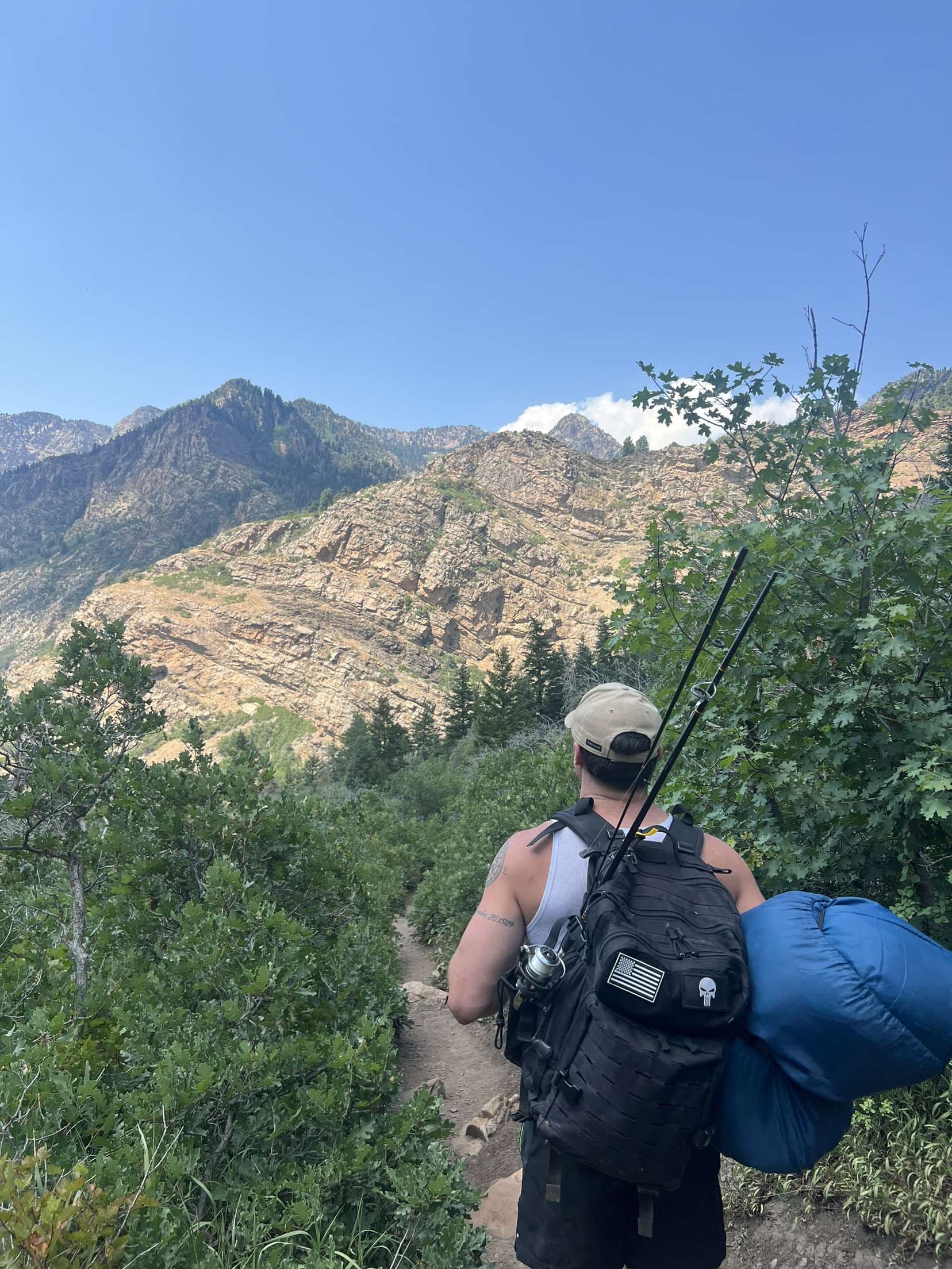 Anthony Vail hiking a trail with fishing gear