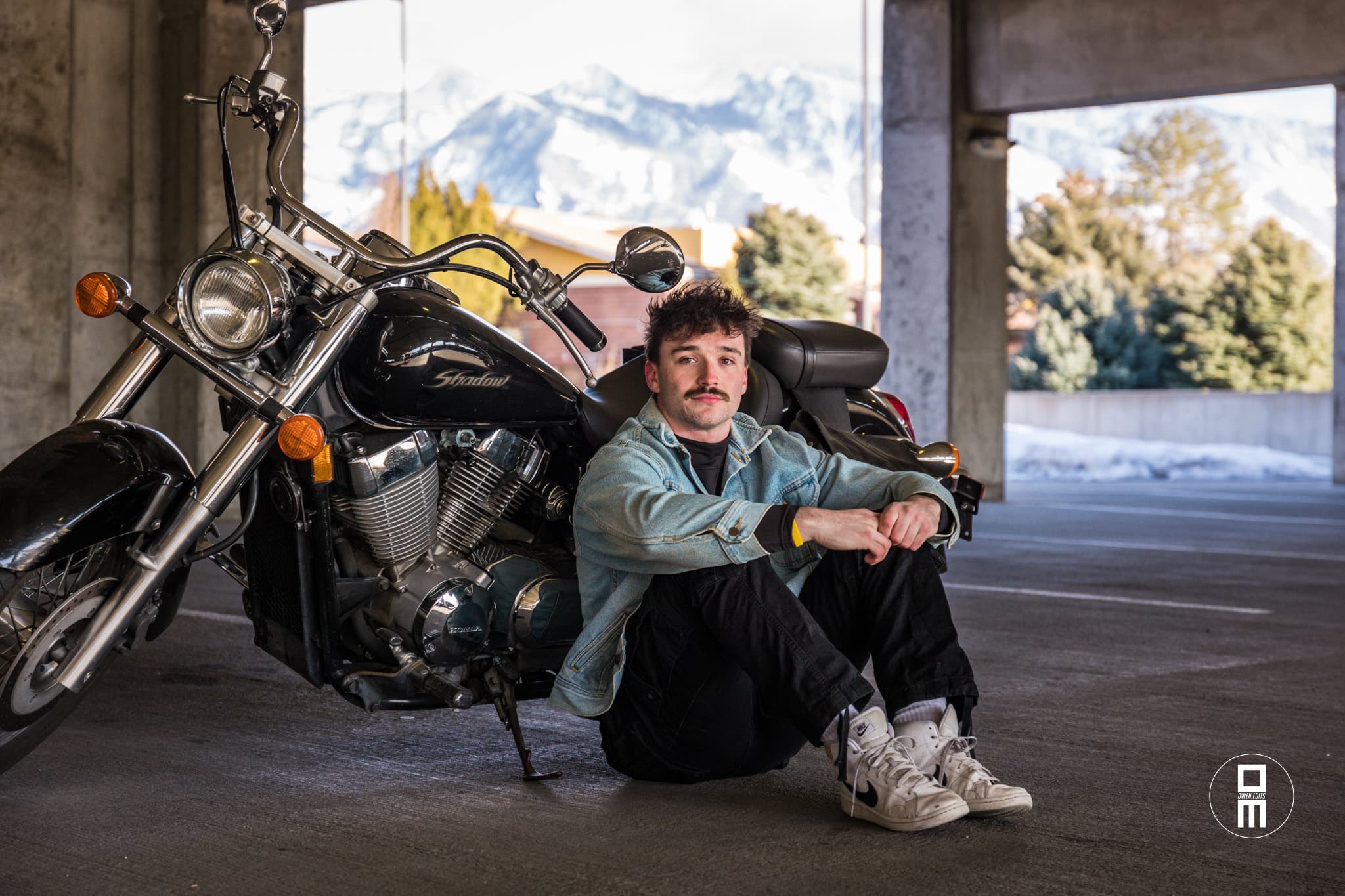 Anthony Vail posted up by his motorcycle