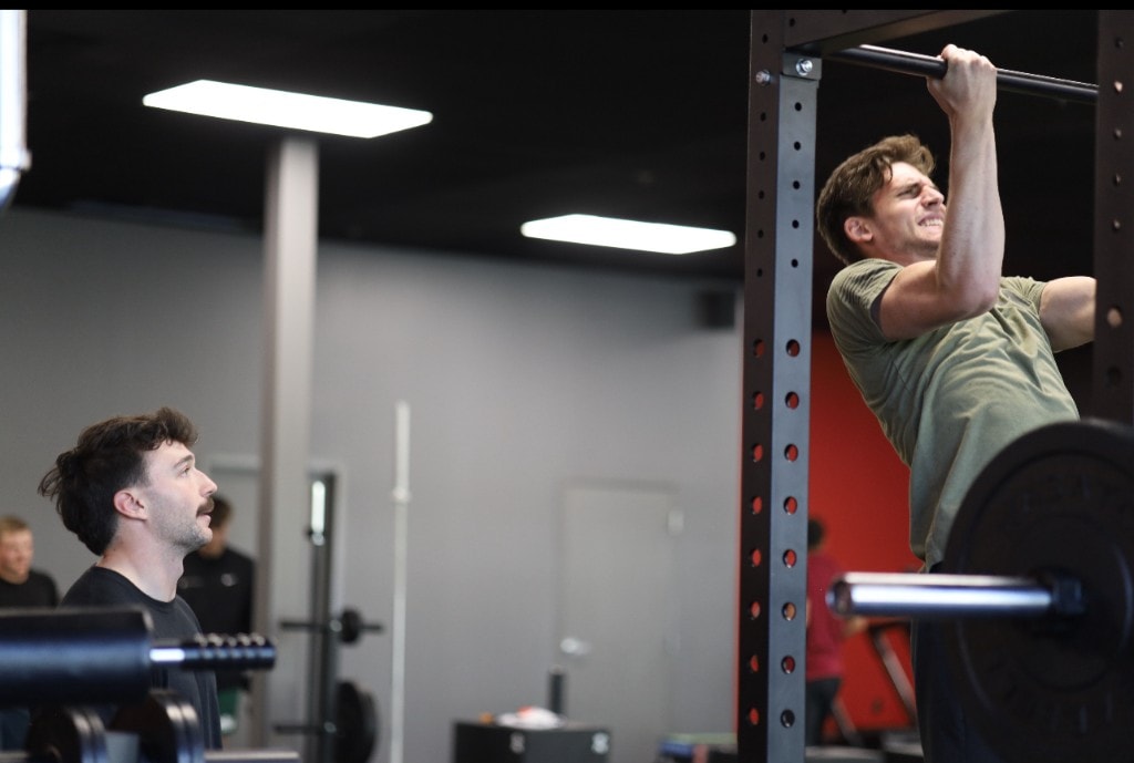 Coach Anthony coaching client on pull-ups